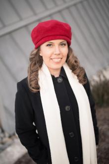 white woman in red beret and black dress coat